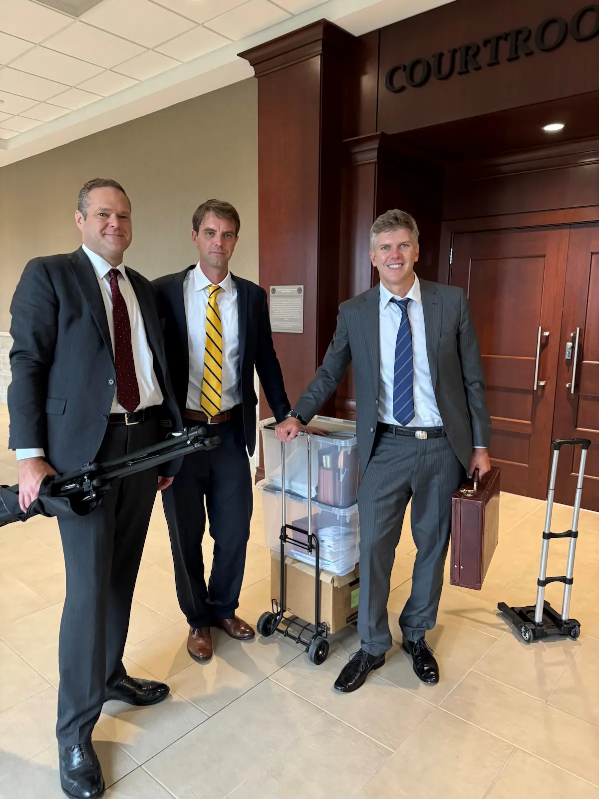 the attorneys of evans moore at the courtroom doors