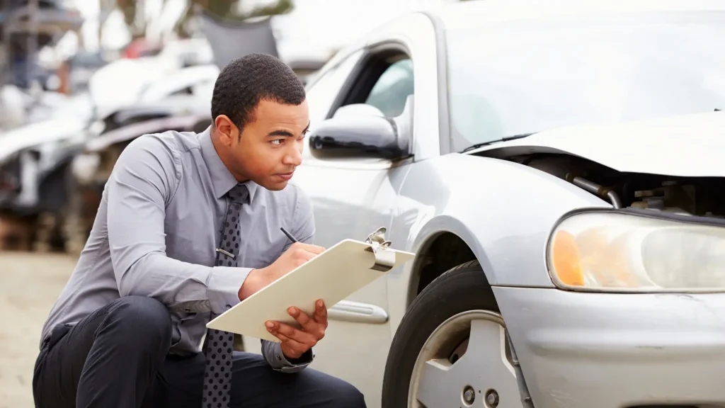Man inspecting a car with a clipboard